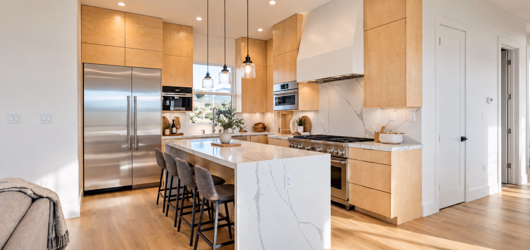 Maple kitchen with a white waterfall island and glass pendants